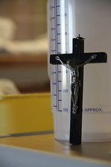 Crucifix leaning against water bottle